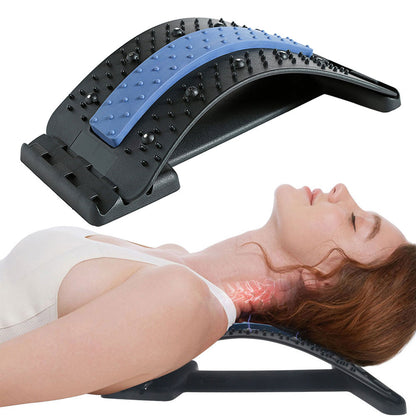 A person lying on their back with their head and neck resting on a Valga Back Massage Pad, a black and blue device with adjustable massage points. The curved stretcher provides lumbar spine relief and support to the neck and back.