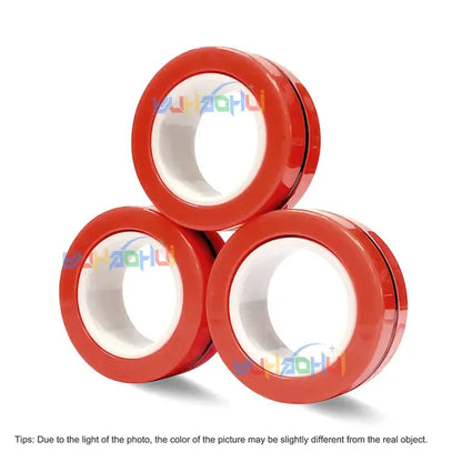 Image of 3Pcs Magnetic Rings Anti-Stress by Valga, arranged in a triangular formation with two rolls at the bottom and one on top, resembling a magnetic ring configuration. Text at the bottom notes that the color in the photo may vary slightly from the actual product due to lighting differences.