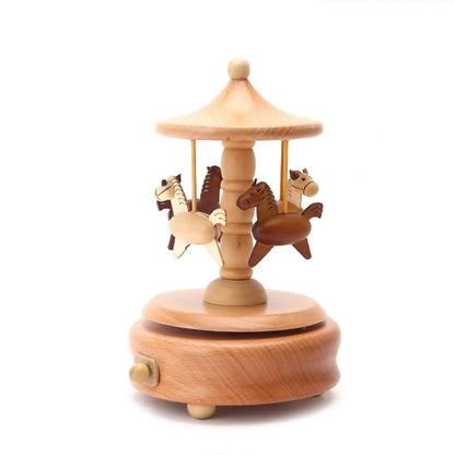 The Valga Music Box - Vintage Wood is a small, beautifully crafted carousel music box, perfect for adding nostalgic charm to your decor. It features four intricately carved and painted horse figures suspended from a central post beneath a slanted roof. The circular base includes a convenient winding key, while the wood tones range from light to dark, making this exquisite piece an ideal heirloom gift.