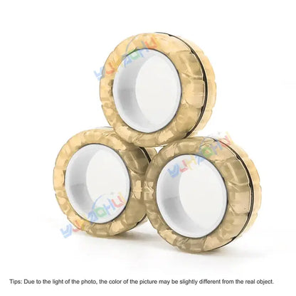 Three circular beige objects with a textured outer surface are stacked in a triangular formation, resembling the Valga 3Pcs Magnetic Rings Anti-Stress. Each ring has a white, smooth center with a black line separating the center from the outer edge. Text at the bottom mentions color variations due to lighting.