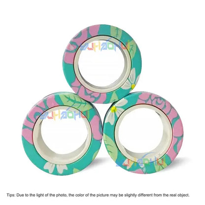 Three rolls of Valga's 3Pcs Magnetic Rings Anti-Stress are stacked in a pyramid shape. This tape, adorned with pink flowers, white leaves, and green foliage on a white background, can add a touch of serenity to any project. Please note there may be slight color variations between the photo and the actual product.