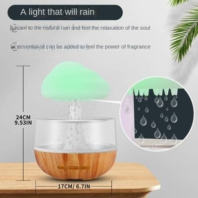 The Valga Desktop Rain Cloud Humidifier, designed to resemble a cloud hovering over a wooden bowl, emits water droplets for a calming ambiance. An inset magnifies the delicate raindrop effect. This aromatherapy diffuser stands 24 cm tall and 17 cm wide.