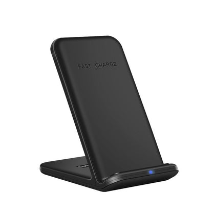 The "3in1 Wireless Fast Charger Dock Station" by Valga is showcased in sleek black, designed specifically for Apple devices. The stand features a slightly tilted angle with "FAST CHARGE" embossed at the top and includes a small blue LED indicator light at the base to signify charging status. This 15W Fast Wireless Charger combines minimalist aesthetics with modern design.