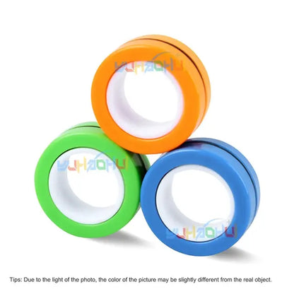 The Valga 3Pcs Magnetic Rings Anti-Stress set features three vibrant rings, each with a distinct white center, meticulously stacked in a triangular arrangement. The set includes orange, green, and blue rings. Please note that lighting in the photo may cause slight variations in color compared to the actual product. These magnetic rings make an excellent anti-stress fidget spinner accessory.