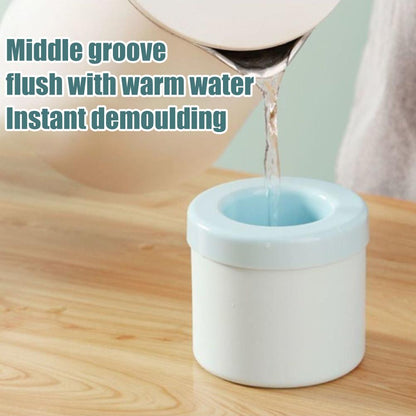 A person is pouring liquid into a white Valga Silicone Cylinder Portable Ice Maker Bucket with a blue rim on a wooden surface. The text on the image reads: "Middle groove flush with warm water for instant demoulding from silicone ice maker.