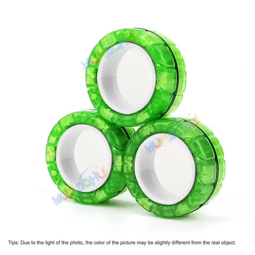 Three green, translucent Valga 3Pcs Magnetic Rings Anti-Stress items are arranged in a triangular formation, perfect for relieving stress. These rings feature white circular centers with black rings around each core. A small text note at the bottom mentions that the item's color may slightly differ due to lighting.