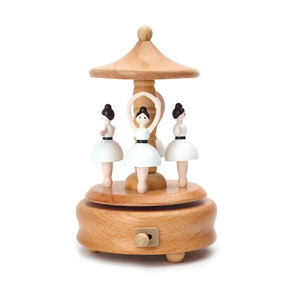 The Valga Music Box - Vintage Wood showcases three elegantly positioned ballerinas in white dresses, gracefully dancing under a conical canopy. The round base includes a convenient winding key on the front, making it an ideal heirloom gift. The central ballerina's arms are raised above her head, adding an extra touch of elegance to this timeless treasure.