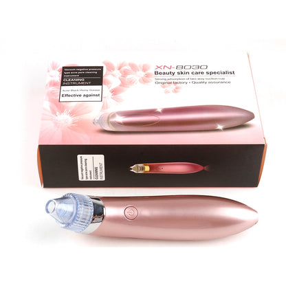 A pink electric 4-in-1 Multifunctional Beauty Pore Vacuum from Valga, featuring a removable suction head, is positioned in front of its packaging box. The box displays the product, its model number XN-8030, and usage details including blackhead removal, deep facial cleansing, and effective vacuum absorption.