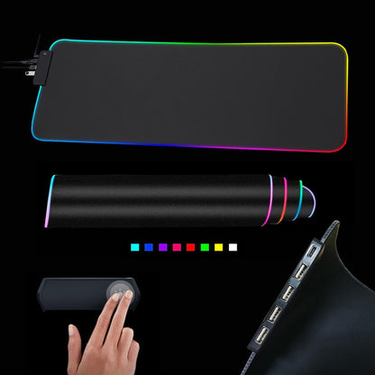 The Valga RGB Mouse Pad with Cable is displayed, featuring vibrant LED lighting along the edges in a sleek black design. Close-up images showcase its compact rolled-up form, a corner equipped with USB ports, and a small control panel being touched to emphasize its touch functionality. This versatile gaming accessory also functions as a convenient USB hub.