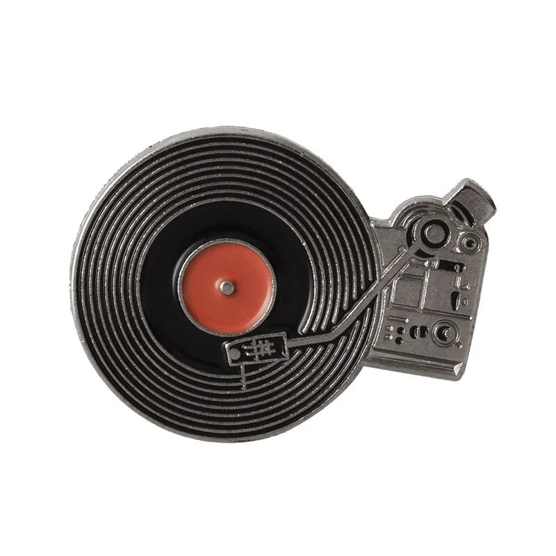 The Punk Music Lovers Enamel Pin by Valga is a must-have for punk enthusiasts. Designed to resemble a vintage vinyl record player, it features a black record with a red center and turntable arm, capturing the spirit of the punk movement. The intricate details include buttons, a stylus, and silver and black elements with red accents.