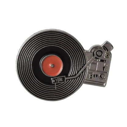 The Punk Music Lovers Enamel Pin by Valga is a must-have for punk enthusiasts. Designed to resemble a vintage vinyl record player, it features a black record with a red center and turntable arm, capturing the spirit of the punk movement. The intricate details include buttons, a stylus, and silver and black elements with red accents.